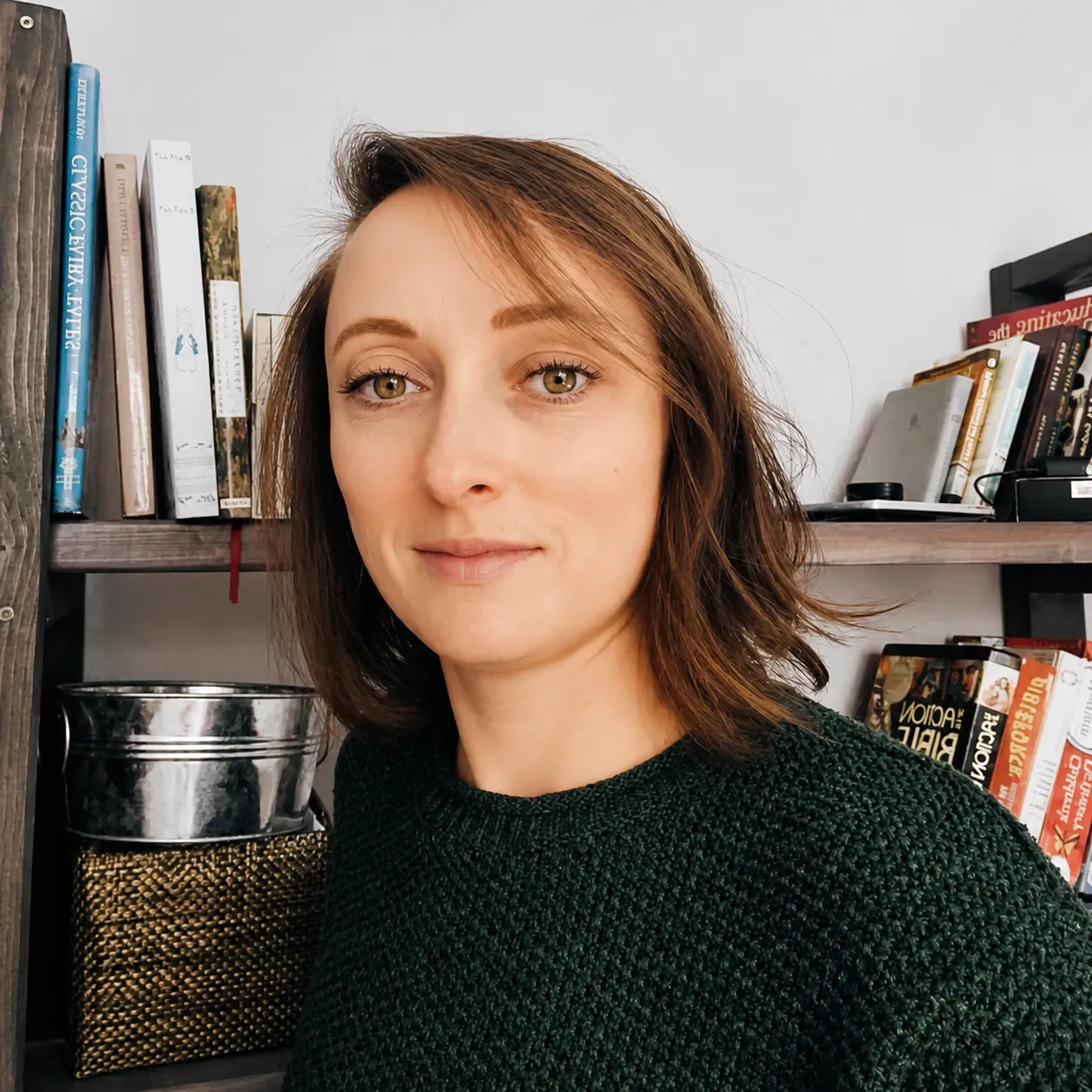 Sheri Centifanto, smiling in front of a bookshelf